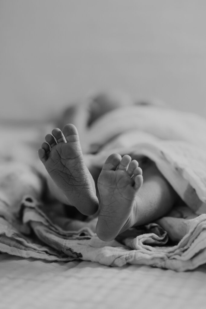 Black and white close up of babies feet